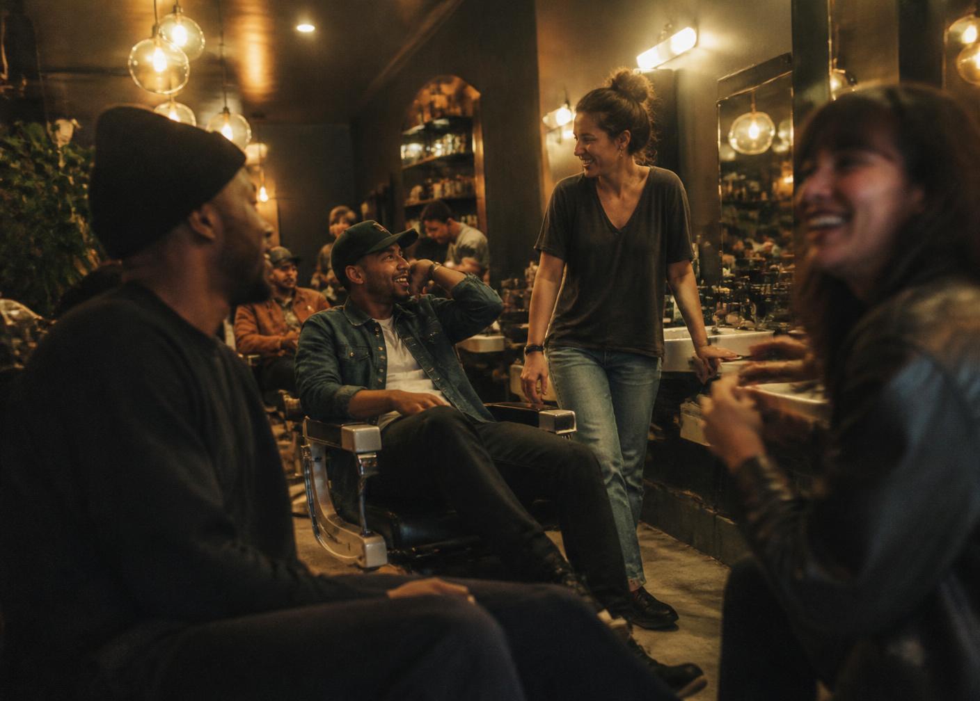Customers and barbers talking inside the shop